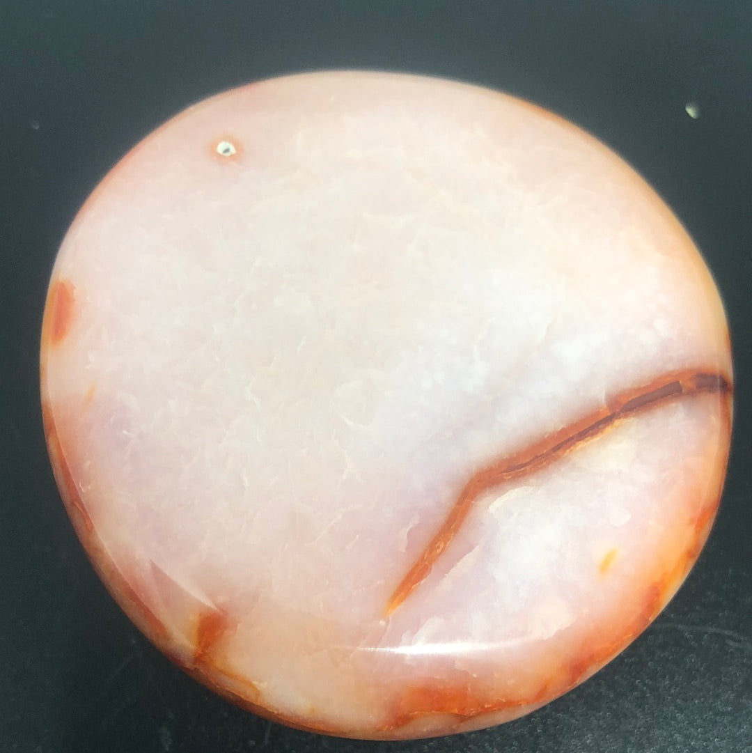 Red carnelian palm stone