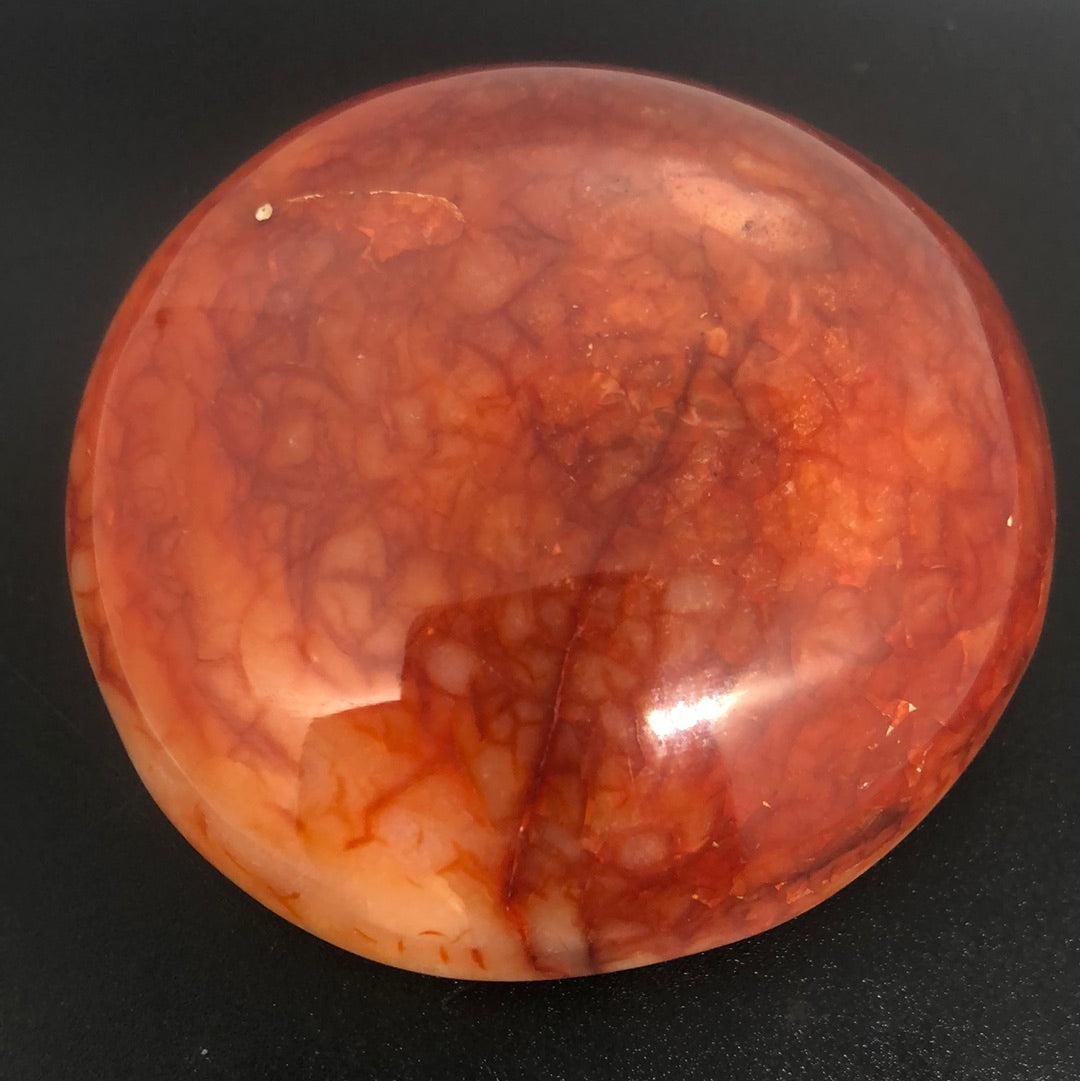 Red carnelian palm stone